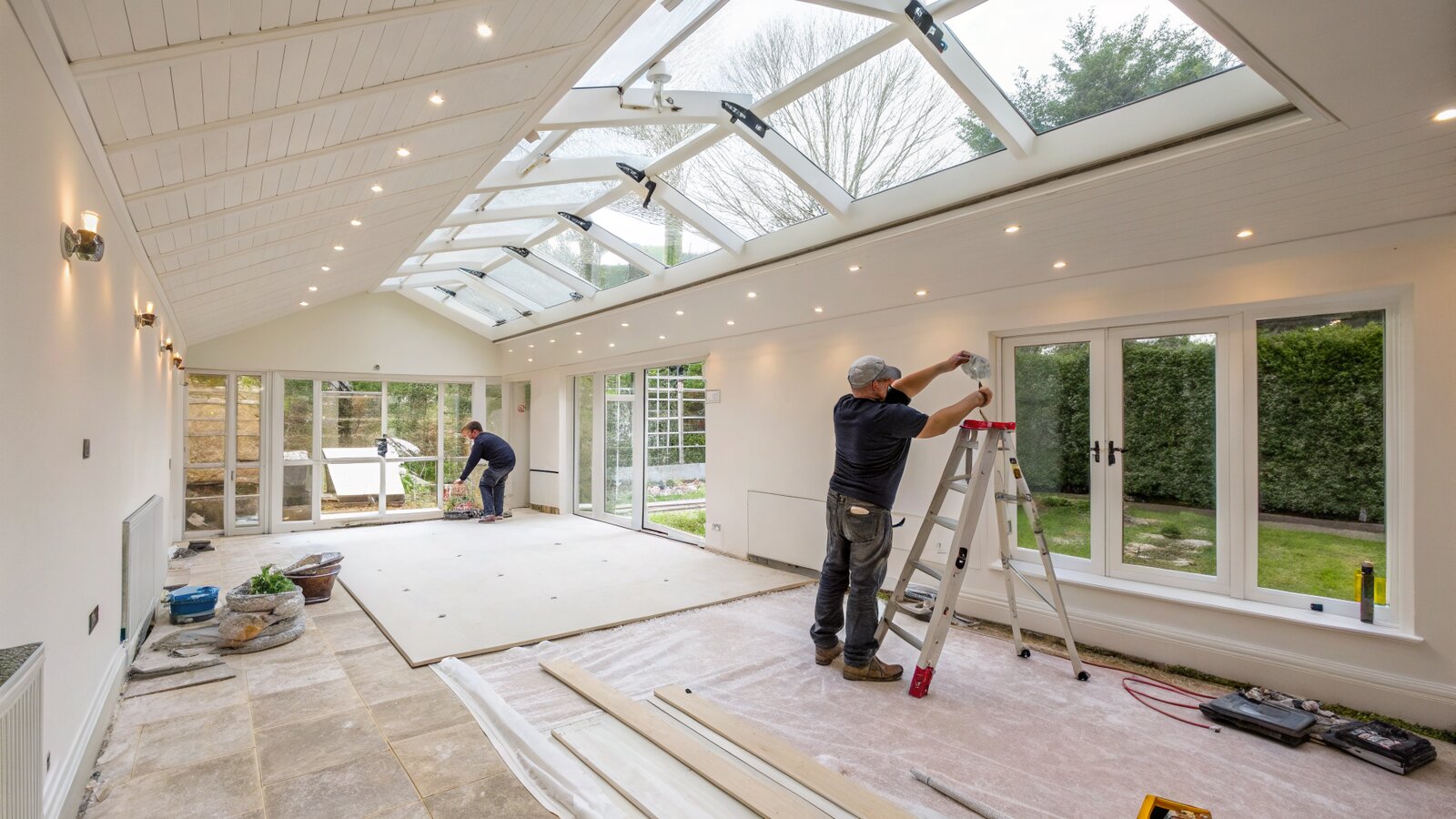 Insulation board fitted between conservatory roof rafters under a new plastered ceiling