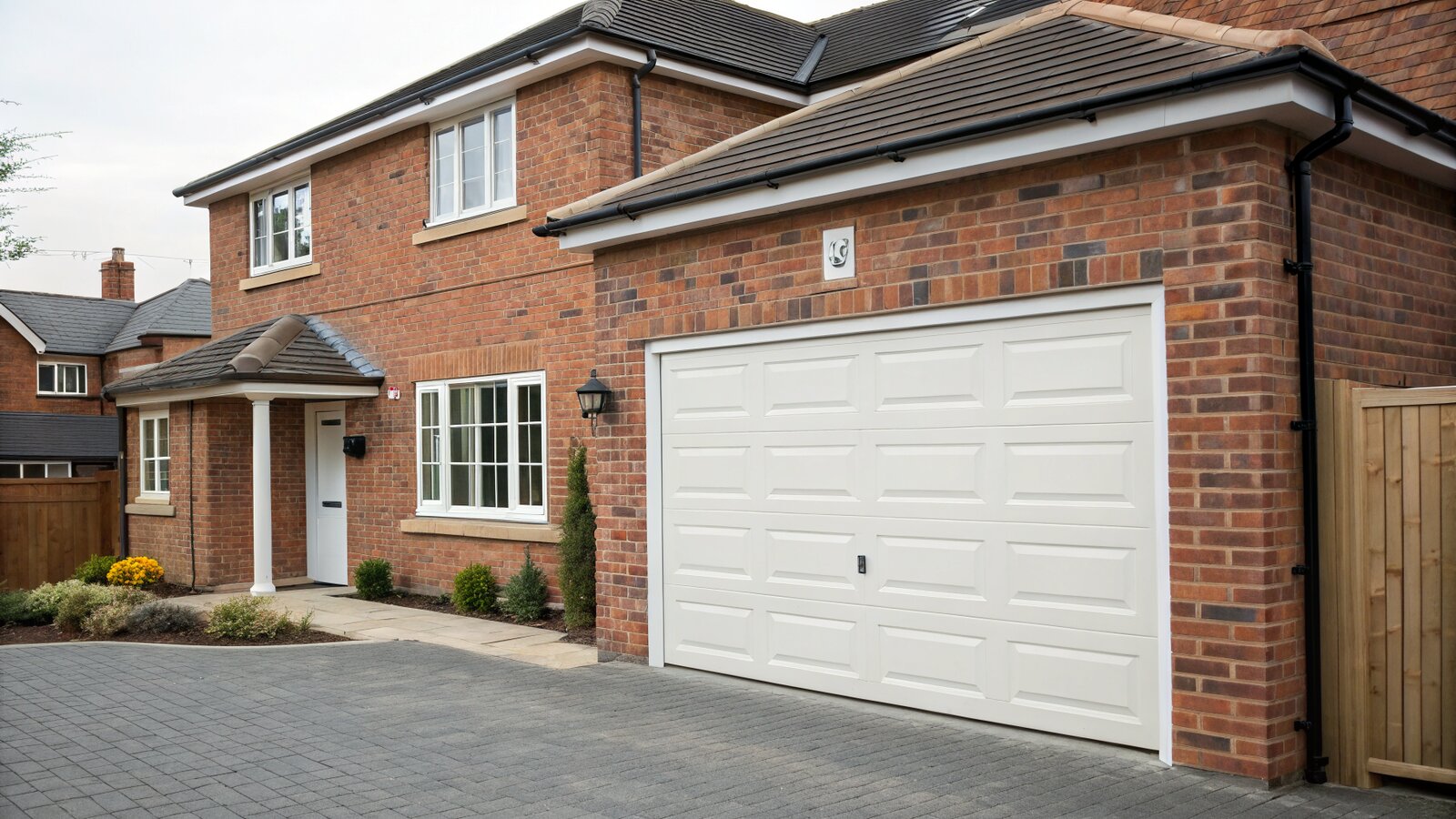 Former garage door opening bricked up with a matching new wall and window on a UK house