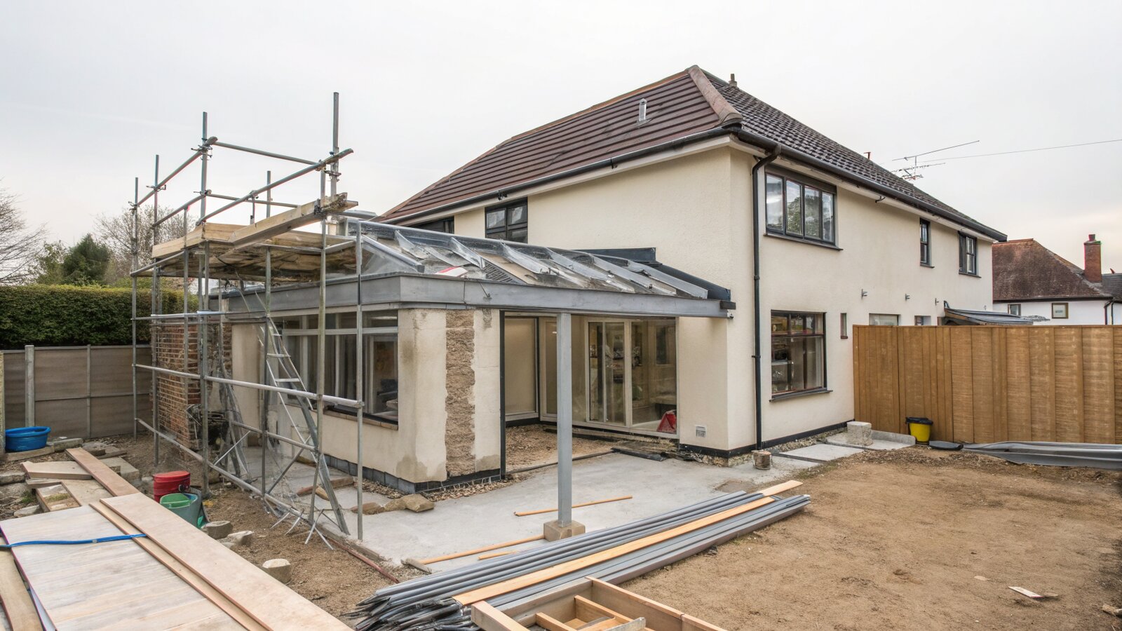 House extension under construction showing steel beams and blockwork at the corner