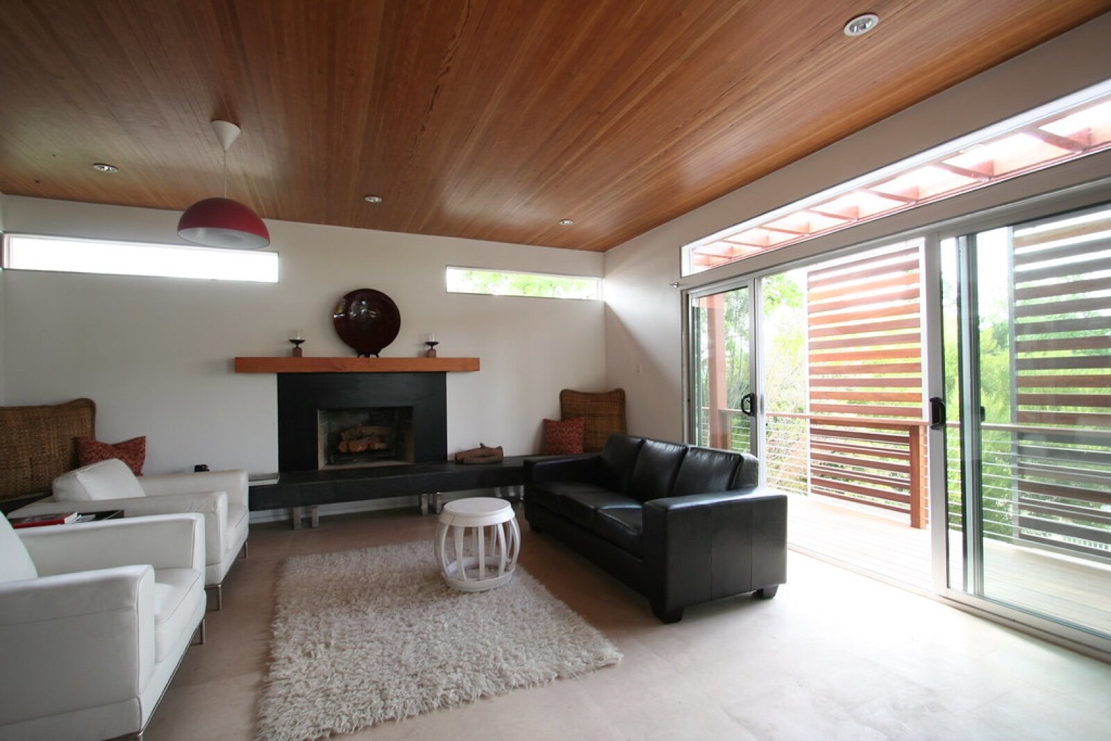 A sliding glass door seen from inside a living room, with one large fixed pane and one sliding panel