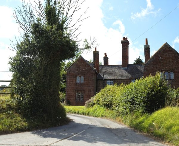 Red brick gabled houses with tall chimneys on Station Road, Chillenden, Kent