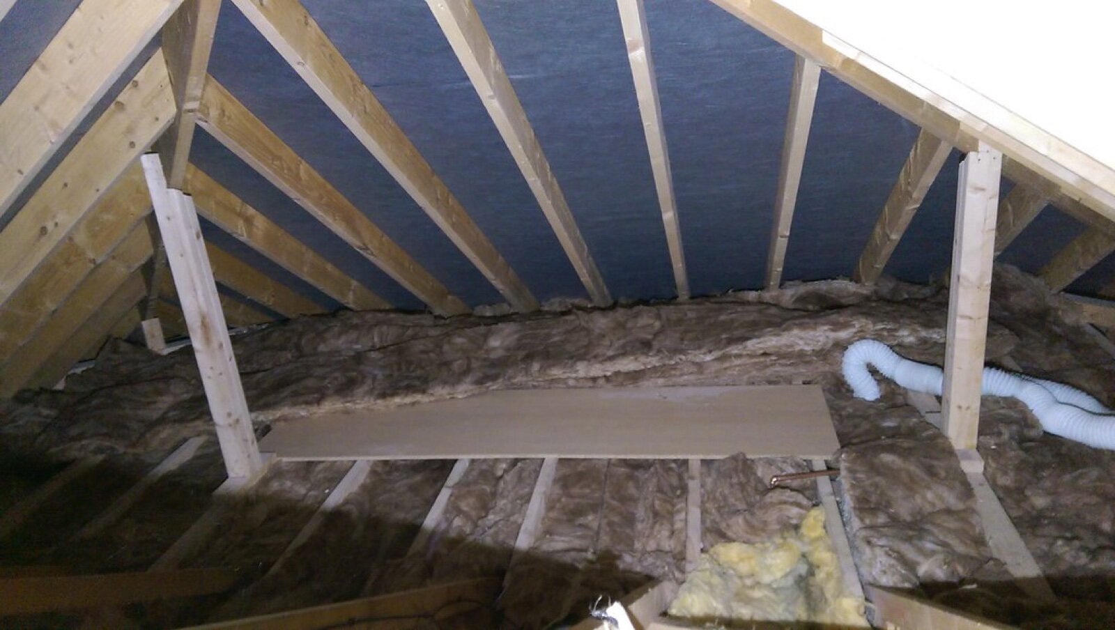 Mineral wool loft insulation laid between ceiling joists under a roof